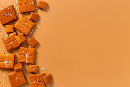 Frame of toffee caramel candies with sea salt, top view