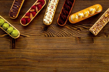 Flatlay of color eclairs with pistachio raspberries and chocolate