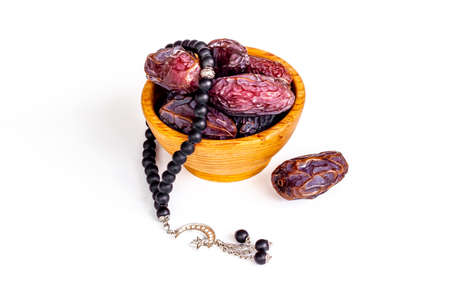 Dates fruits and Islamic rosary with star and crescent. Ramadan Kareem conceptの写真素材