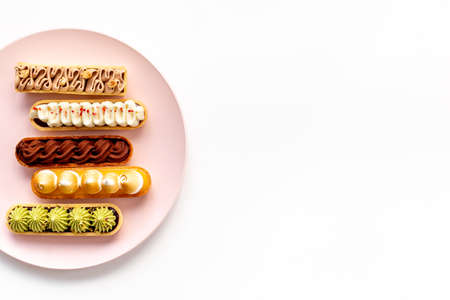 Cupcakes eclairs with pistachio raspberries and chocolate cream toppingの写真素材