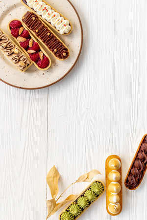 Eclairs with pistachio raspberries and chocolate cream toppingの写真素材