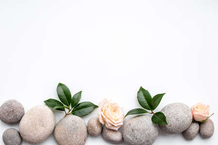 Relax composition with spa stones and pink rosesの写真素材