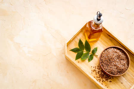 Bottle of sesame cooking oil with seeds in bowlの写真素材