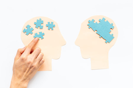 Communication. Chaos and peace in brain - two paper human heads with puzzles