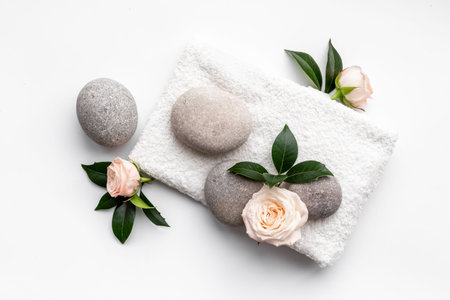 Spa massage stones with white towel. Beauty treatment flatly