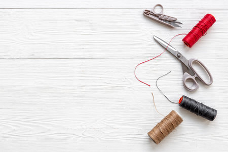 Tailoring scissors with bobbins of thread. Sewing background