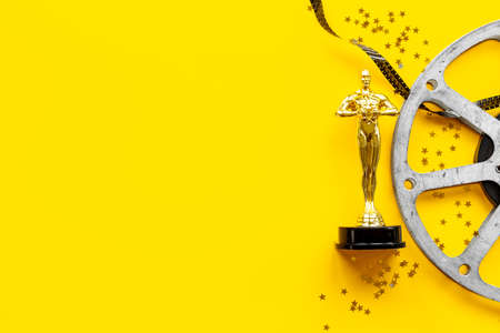 Film reel video tape with golden award statueの写真素材