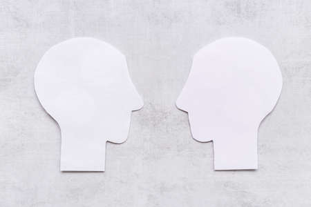 Human communication concept with two paper human headsの写真素材
