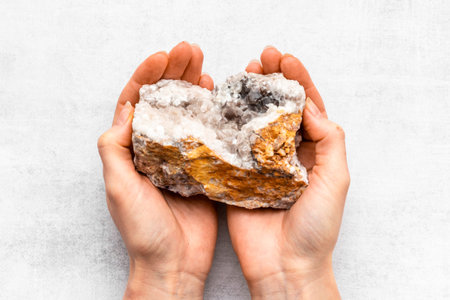 Natural crystal mineral stone in hands. Crystal texture closeupの写真素材