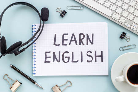 Learnging English concept. Handwritten text on notebook on student tableの写真素材