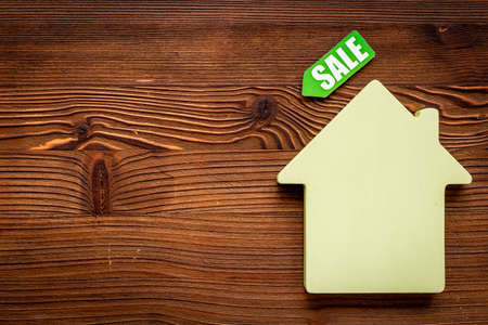 House for sale concept. Sale label with wooden house modelの写真素材