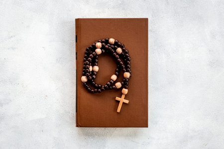 Christian religion concept. Bible book and rosary beads with cross