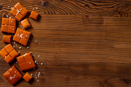 Homemade caramel pieces with salt. Candies background