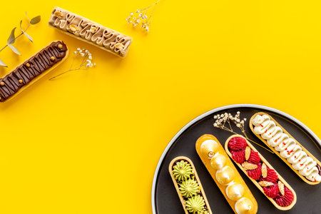 Cupcakes eclairs with pistachio raspberries and chocolate cream toppingの写真素材