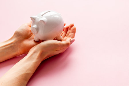 Piggy bank with hands close up. Family budget conceptの写真素材