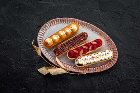 Top view of sweet bakery eclairs with color toppingの写真素材