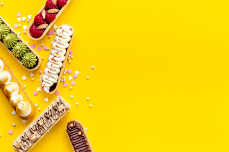 Group of decorated eclairs with pistachio raspberries and chocolate