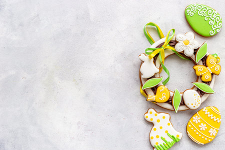 Easter sweet wreath made of bunny and eggs cookies, top view