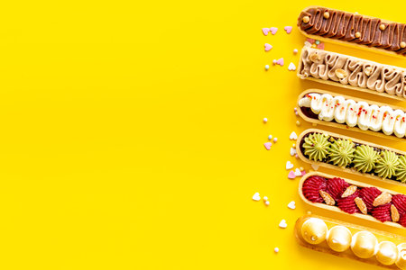 Flatlay of color eclairs with pistachio raspberries and chocolate