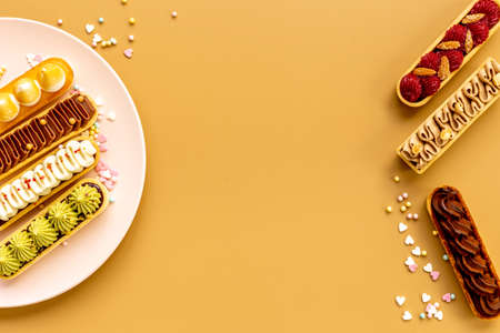 Set of french dessert eclairs with colorful toppingの写真素材