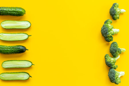 Flatly of green vegetables - broccoli and cucumber. Food background