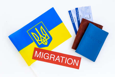 Ukrainian refugees migration concept. Ukraine flag and passportsの写真素材