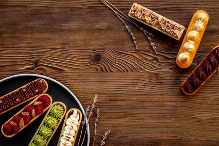 Flatlay of color eclairs with pistachio raspberries and chocolateの写真素材