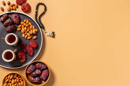 Ramadan Kareem background. Islamic rosary and dates fruits with teaの写真素材