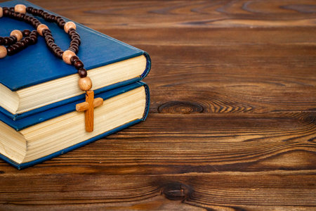 Christian rosary beads with cross and Bible book