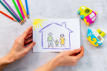 Drawing of parents and child at home. Adoption conceptの写真素材