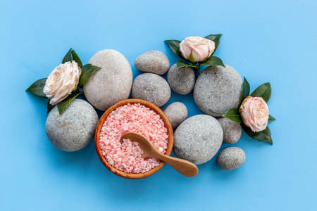 Relax background - spa stones with roses and sea salt, top viewの写真素材