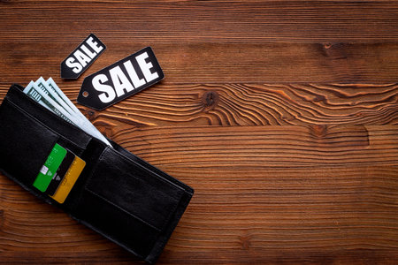 Price sale label and wallet with banknotes and bank cards