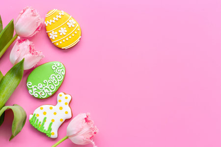 Happy Easter with pink tulips and cookies. Easter background