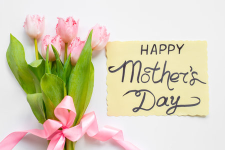 Greeting card Happy Mothers day with pink tulips, top view