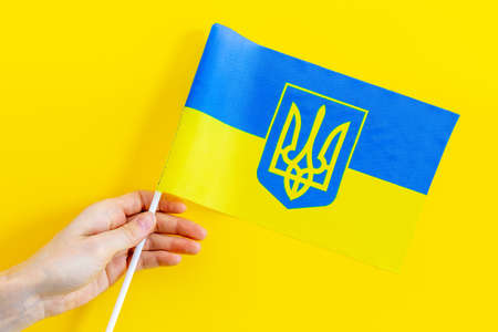 Hand are holding Ukrainian flagの写真素材
