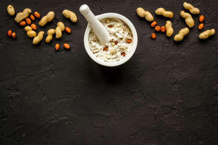 Pestle peanut flour - nuts with mortar on kitchen tableの写真素材