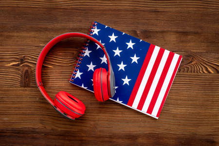USA flag on notebook with headphones. E-learning language conceptの写真素材