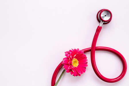 Breast cancer and women health background with red flowerの写真素材