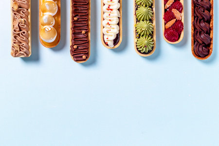 Sweet food pattern of eclairs with color topping. Sweet shacks