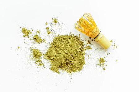 Isolated splash of matcha tea powder on white background