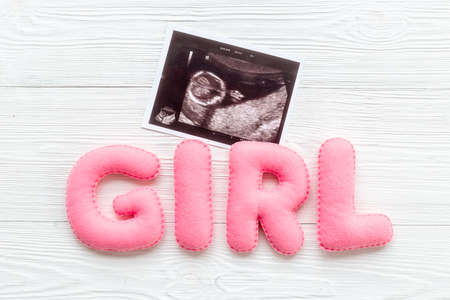 Ultrasound scan of unborn baby with letters girlの写真素材