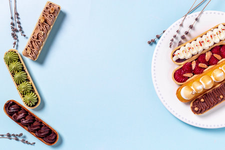 Flatlay of color eclairs with pistachio raspberries and chocolateの写真素材
