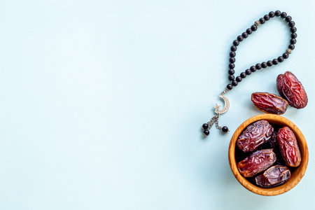 Ramadan concept. Black islamic rosary with crescent with dates fruits