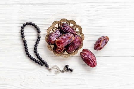 Ramadan concept. Black islamic rosary with crescent with dates fruitsの写真素材