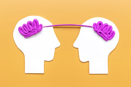 Human connection and communication. Brain on two paper human heads
