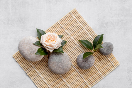 Spa massage stones with pink roses, beauty treatment backgroundの写真素材