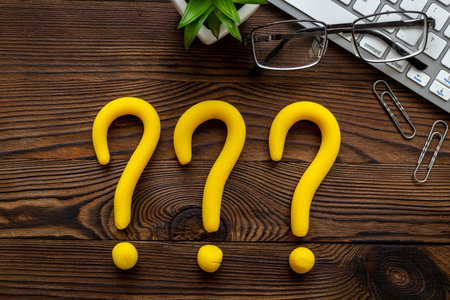 Question mark signs on office table. Customer support servise or FAQ concept