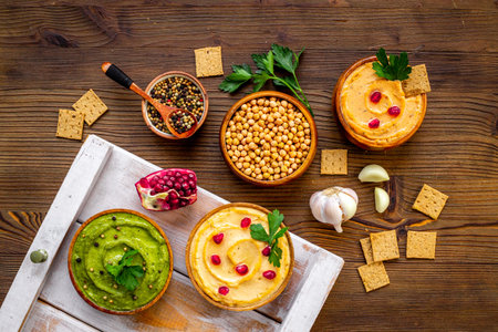 Flatlay of different types of colorful hummus in bowls. Vegan food backgroundの写真素材