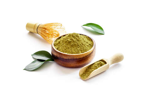 Green matcha powder in bowl with bamboo whiskの写真素材