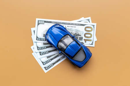 Saving money to buy a car. Toy car with money cashの写真素材